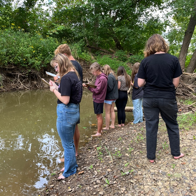 Students work near the creek on descriptive language