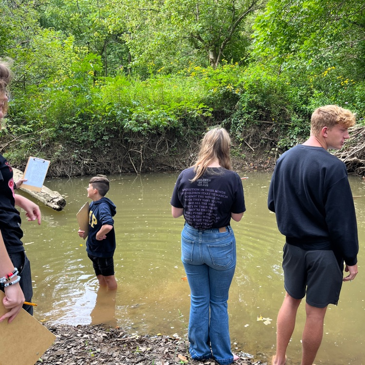 Students work near the creek on descriptive language